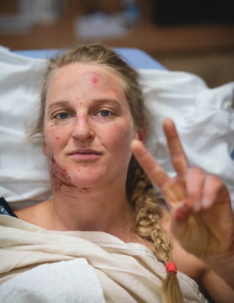 Emily Harrington at the hospital giving a peace sign