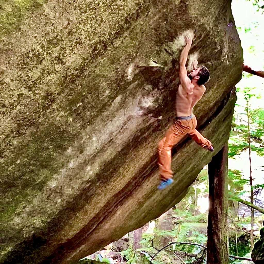 Coach Chris using his rock climbing strength